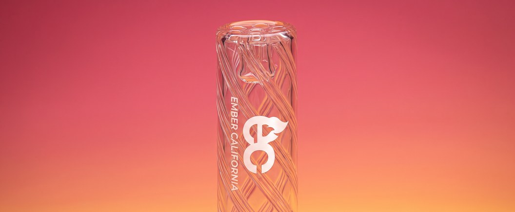 Spiral glass tip standing upright on a pink and orange background